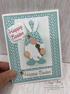 a handmade easter card with a bunny holding an egg in it's mouth