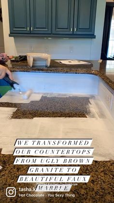 a person cutting up some paper on top of a kitchen counter with scissors and tape