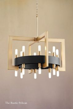 a chandelier with lights hanging from it's sides and an open rectangular frame