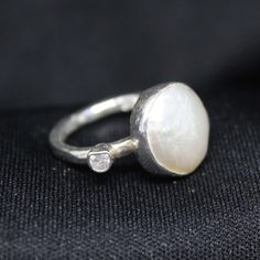 Reveal Timeless Elegance! Looking for a stunning accessory that blends tradition with contemporary appeal? Our collection is just for you! Our Natural Pearl Ring is here to grace you. Enjoy the charm of our Natural Pearl Ring, a masterpiece meticulously handcrafted to perfection. Made of 925K Sterling Silver, this ring reflects the richness of Roman art while adding a modern touch. This stunning piece features a brilliant white pearl, a symbol of purity and sophistication. The 14K White Gold Eur Contemporary Polished Jewelry For Wedding, Sterling Silver Open Pearl Ring With Polished Finish, Contemporary Diamond Jewelry For Wedding, Artisan White Sterling Silver Ring, Contemporary Silver Jewelry With Gemstone, Contemporary Gemstone Rings For Gifts, Artisan White Gold Jewelry For Anniversary, Contemporary Gemstone Rings For Gift, Contemporary Silver Diamond Jewelry