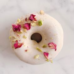 a donut with white icing and pink flowers on it