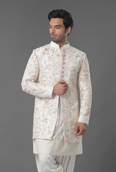 Ivory Color Embroidered Sherwani Beige Raw Silk Sherwani With Dabka, Beige Sherwani With Resham Embroidery For Transitional Season, Festive Beige Set With Gold Embroidery, Ceremonial Off White Sets With Chikankari Embroidery, Ceremonial Off White Chikankari Embroidery Sets, Cream Sherwani With Chikankari Embroidery And Long Sleeves, Beige Raw Silk Sherwani With Zari Work, Unstitched Cream Sherwani With Intricate Embroidery, Traditional Off White Raw Silk Bandhgala