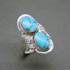 Embrace the spirit of the 1970s with this bohemian-inspired sterling silver ring, adorned with two blue natural turquoise stones, highlighted with Boho design floral accents. Turquoise, known as the December birthstone, is said to bring peace and tranquillity to its wearer. Perfect for Boho chic enthusiasts, this vintage piece will arrive in a gift box Ring diameter 18.2 mm / US size: 8 / British size: Q / European size: 56 3/4 Ring face measures 1 1/5 inches (3.0 cm) tall Weight: 8.6 grams The Bohemian Silver Turquoise Ring With Stone Setting, Bohemian Blue Turquoise Ring Stamped 925, Silver Bohemian Turquoise Ring With Stone Setting, Bohemian Turquoise Ring For Anniversary, Bohemian Turquoise Gemstone Ring For Anniversary, Adjustable Traditional Turquoise Ring, Silver Bohemian Turquoise Ring Hallmarked, Bohemian Silver Turquoise Ring Hallmarked, Bohemian Hallmarked Turquoise Ring For Anniversary