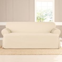 a white couch sitting on top of a hard wood floor