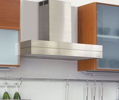 a stove top oven sitting inside of a kitchen next to cupboards and cabinets with glass doors