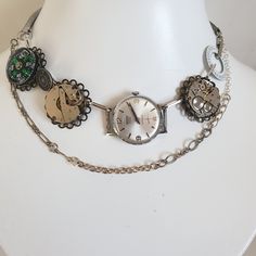 I have recycled three vintage mechanical watches for this Steampunk-inspired necklace adding a brass-with-white calendar watch dial, a reclaimed metal utility button ["guaranteed authentic"], bracelet sections from another antique wristwatch, a contemporary button compass as another contrast dial and reclaimed lengths of chain. To complete the total length of approximately 16.00 inches I added paperclip chain. It has been photographed at 14.00 inches. Watch Choker, Compass Vintage, Clock Necklace, Handmade Watch, Steampunk Cosplay, Button Necklace, Watch Dial, Compass Necklace, Assemblage Jewelry