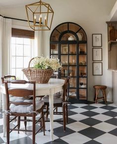 a dining room table with chairs and a basket on it