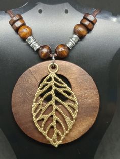 Beautifully stained wooded pendant and beads paired with a metal leaf in a long brown cord. Pendant approx 5cm. Cord upto 80cm Brown Wooden Bead Pendant Jewelry, Brown Wooden Beads Pendant Jewelry, Brown Wooden Pendant Jewelry, Brown Wooden Beads Pendant Necklace, Brown Wooden Beads Long Necklace, Adjustable Brown Wooden Necklaces, Young Life Camp, Fairy Heart, Finger Heart