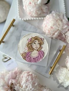 a white plate topped with a drawing of a girl surrounded by pink carnations