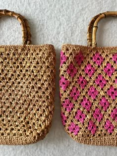 two straw bags with pink and brown handles