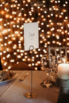 a place card holder on a table with candles