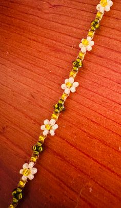 This beadwork project is a daisy bracelet with a lobster claw clasp closure. Different size beads can be used in this design, but this particular one is done with size 11/0 Miyuki glass seed beads. It will fit from 7" to 8" wrist.  If you would like this bracelet done in a different size or colors, let me know and I'll set up a listing for you. Handmade White Beaded Flower Bracelets, Handmade White Flower Beaded Bracelets, White Handmade Flower Shaped Beaded Bracelets, Handmade White Flower-shaped Beaded Bracelets, White Beaded Flower Bracelets, White Beaded Flower-shaped Bracelet, White Flower-shaped Beaded Bracelets, White Flower-shaped Bracelet With Tiny Beads, White Beads With Lobster Clasp For Gift