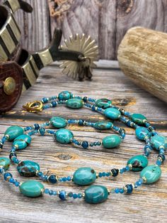 These beautiful turquoise nuggets (14 x 17 mm) are a gorgeous teal color with black  matrix. Paired with ocean blue faceted apatite and round apatite, and small goldcolored discs to accentuate the teals. This is a very long necklace (37") and can easily be doubled. Toggle closure. Turquoise Jewelry With Round Natural Stone Beads, Artisan Chrysocolla Jewelry With Polished Beads, Turquoise Rondelle Beaded Gemstone Necklaces, Turquoise Beaded Necklace With Round Gemstone Beads, Turquoise Gemstone Necklace With Round Beads, Blue Faceted Oval Beads Jewelry, Turquoise Polished Chrysocolla Beads Jewelry, Turquoise Chrysocolla Jewelry With Polished Beads, Turquoise Chrysocolla Polished Beads Jewelry