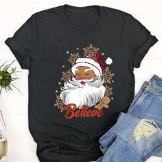 Ugly Christmas T Shirt, Believe Afro Santa African American Christmas Black Pride T Shirt, Christmas Tshirt Designs The T-Shirt, a timeless wardrobe staple, combines comfort with effortless style. Crafted from soft, breathable fabrics, it ensures a cozy fit for everyday wear. Its versatility makes it a go-to choice for various occasions, from casual outings to... Black Santa Christmas Shirts, Christmas Tshirt Designs, African American Christmas, Pride T Shirt, American Christmas, Black Santa, Christmas Tshirt, Christmas Black, Timeless Wardrobe