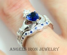 This is an Irish Celtic Claddagh Ring set made of .925 sterling silver with a blue sapphire cubic zirconia heart.  Sparkling blue and clear pave crystals make this ring even more impressive. May be ordered in clear CZ or black CZ crystals. Bands measure 6mm when worn together. Comes nicely boxed for the perfect gift! This listing is for the ring and the band. Celtic Claddagh Ring, Irish Wedding Rings, Blue Sapphire Wedding Ring, Claddagh Ring, Celtic Wedding Rings, Celtic Rings, Claddagh Rings, Irish Celtic, Jewelry Unique