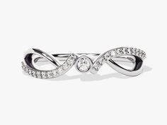 a white gold and diamond ring on a white background with the word love written in it