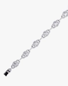 - Halo and Link Bracelet with sterling silver- Made in Sterling silver set with a high-quality Cubic Zirconia. - Stone size: 4.00 mm, 1.10 mm- Length: 7 inch Sterling silver925 Sterling Silver is an alloy made of 92.5% pure silver and 7.5% copper. We plate our silver jewelry in rhodium, which gives it extra shine and durability. Rhodium is one of the costliest precious metals due to its rarity.CareH2O sensitive. Avoid water when wearing your piece, because over time the sterling silver will oxid Sterling Silver Diamond Cut Tennis Bracelet, Sterling Silver Diamond Cut Chain Bracelet For Anniversary, Sterling Silver Tennis Bracelet With Diamond Accents, Silver Diamond Jubilee Bracelet In Platinum, Silver Cubic Zirconia Crystal Bracelet Fine Jewelry, Silver Classic Crystal Bracelet As Gift, Sterling Silver Diamond Cut Bracelets, Sterling Silver Diamond Cut Bracelet, Silver Cubic Zirconia Crystal Bracelet