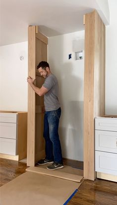 a man is standing in the middle of an unfinished room