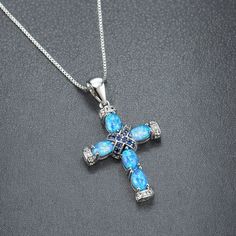 PRODUCTION Introducing our Opal Necklace Dainty, a delicate and meaningful piece that combines elegance and spirituality. This necklace features a stunning opal cross pendant, beautifully crafted in sterling silver and adorned with 18k white gold plating. The blue opal gemstone adds a touch of celestial beauty, symbolizing serenity and inner peace. Whether worn as a symbol of faith or as a fashion statement, this Opal Cross Necklace is a striking addition to any jewelry collection. Perfect for those born in October or anyone seeking a unique and eye-catching pendant, this necklace is sure to inspire and captivate. Embrace the beauty of the opal and express your spirituality with this exquisite piece today. PACKAGING AND GIFTING Free gift box and card Each product comes in a pretty box. SHI Blue Cross Spiritual Necklace, Spiritual Blue Cross Pendant Necklace, Blue Clavicle Chain Necklace For Wedding, Blue Cross Pendant Necklace For Gift, Spiritual Birthstone Cross Pendant Jewelry, Blue Spiritual Cross Jewelry, Blue Cross Spiritual Jewelry, Blue Crucifix Necklace For Spiritual Wear, Blue Crucifix Necklace For Spiritual Purposes