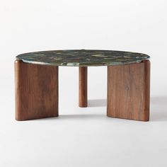 a round table with wooden legs and a green marble top, on a white background