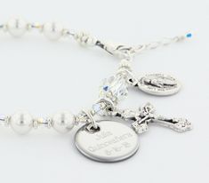 "A dazzling First Holy Communion bracelet, Confirmation bracelet, or Quinceanera bracelet. The ornate and delicate Rosary Bracelet has 10 Swarovski Pearls to represent the Hail Mary beads and one Swarovski Crystal as the Our Father bead. It comes with a Crucifix and a Miraculous Medal dangling near the clasp. It is available with or without an Engraved Disc and it comes with your choice of a Gift Message that is elegantly boxed for simple gift giving. Add an Engraved Disc - Select a Disc option. Adjustable Hypoallergenic Charm Bracelet For Weddings, Personalized Adjustable Crystal Bracelet For Wedding, Personalized Silver Crystal Bracelet, Adjustable, Personalized Adjustable Silver Rosary Bracelet, Personalized Adjustable Crystal Bracelet For Anniversary, Silver Adjustable Rosary Bracelet For Wedding, Personalized Silver Rosary Bracelet For Confirmation, Adjustable Jubilee Crystal Bracelet For Anniversary, Elegant Personalized Adjustable Rosary Bracelet