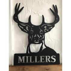 a metal deer head with the word millers on it's face and antlers