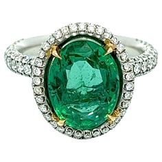 This exquisite ring boasts a 4.91-carat oval-shaped Colombian emerald, elegantly encircled by round diamonds that gradually taper down halfway on both sides. The emerald is set in platinum, ensuring maximum security and stability. You can rest assured of its top-notch quality and authenticity as it is GIA certified. This ring is bound to capture attention and make a bold fashion statement wherever you go. In Dept Description Emerald: 3.61CT Total Weight, Color Green, Oval Shape Diamonds: 1.36CT Luxury Oval Tsavorite Ring, Green Oval Emerald Ring In Platinum, Oval Emerald Ring With Pave Diamond Setting, Oval Emerald Ring With Diamond Pave Setting, Oval Emerald Rings With Pave Setting, White Gold Emerald Ring With Pave Setting, Oval Shape, Oval Emerald Ring With Pave Setting In Platinum, Luxury Oval Emerald Ring With Brilliant Cut, Oval Emerald Ring In White Gold With Diamond