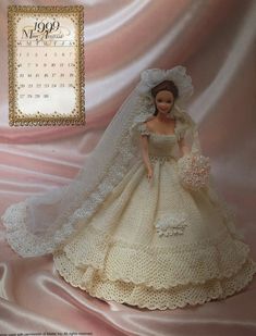 the doll is wearing a wedding dress and veil