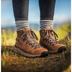 the legs and feet of a person wearing hiking boots