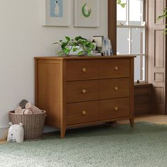 a wooden dresser sitting next to a window