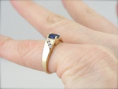 "Simple, refined and set low to the hand, this vintage sapphire ring would make a great piece for day to day wear. The stone has plenty of shine and a rich color, accented by the simply set diamond shoulders. Metal: 14K Yellow Gold Gem: Sapphire .48 Carat Gem Measurements: 4 x 5.8 mm, Oval Accent: 6 Diamonds .18 Carat Ring Size: 4.75 Marks: \"O14KT<>61B\"Stamped on the inside band SKU: 65UE3E-D Each piece has been identified and graded by a Graduate Gemologist who has been certified by the Vintage Sapphire Ring, Vintage Sapphire, Ladies Ring, Eternity Bands, Deep Blue, Rich Color, Sapphire Ring, Blue Sapphire, Women Rings