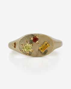 a yellow gold signet ring with two different colored stones