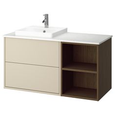 a white sink sitting next to a wooden cabinet with two drawers and a faucet