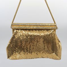 This vintage mesh gold handbag is in lovely vintage condition.  The bag is a long spring clasp bag adorned with three rows of rhinestone.  Two clear and the centre aurora borealis.  All rhinestones are in tact and none missing.  5 of the clear rhinestone seems to have lost their shine but do not deflect from the beauty of the bag.  The spring clasp opens and closes perfectly.   The mesh tiles are all in tact and none are missing.  All in great condition with minimal signs of wear.  Gold and shim Vintage Gold Shoulder Bag For Party, Gold Retro Shoulder Bag For Evening, Retro Gold Shoulder Bag For Evening, Gold Sparkling Rectangular Evening Bag, Sparkling Gold Rectangular Evening Bag, Vintage Party Bags With Rhinestones, Gold Sparkling Evening Bag, Retro Gold Bag For Events, Retro Gold Bags For Events