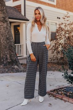 - These new pants are boss babe chic! - Unlined black and white plaid material - A waistline with belt loops, a hidden zip fly, and hook closure - Pleated detail - Functional side pockets - A relaxed silhouette that ends in straight hemlines Chic Plaid Bottoms For Business Casual, Plaid Pants With Pockets For Business Casual, Plaid Business Casual Pants With Pockets, Chic High-waisted Plaid Pants, Plaid Pants For Business Casual In Fall, Black Houndstooth Office Pants, Black Houndstooth Pants For Office, Chic Plaid Houndstooth Pants, Chic Houndstooth Pants For Workwear