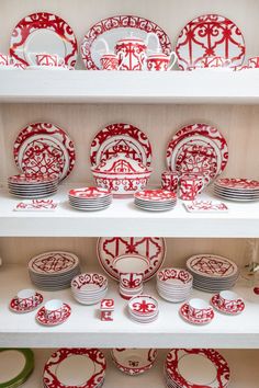 red and white plates on shelves in a store