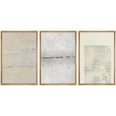 three framed art pieces, each with different lines and shapes in them on a white wall