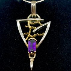 Beautiful Amethyst Sterling Silver pendant necklace with Gold accents This stone has a rich purple color of royalty. The unique design makes this pendant one of a kind. It is perfect for adding a touch of color to your wardrobe! The clasp is hinged for ease and comfort. This is natural Amethyst. NOTE: Images do not reflect number and size. Please see detail and table for information. Quantity: 1 pendant Material Type: Amethyst Silver Size: 10x5mm (stone), 2 inch long Color: Purple Silver Gold Le Amethyst Pendant With Polished Finish, Purple Necklace With Polished Finish As Gift, Purple Amethyst Amulet Jewelry, Amethyst Large Pendant Jewelry Gift, Purple Pendant Necklace With Large Pendant, Purple Necklace With Large Round Pendant, Purple Necklace With Large Pendant, Purple Pendant Jewelry For Anniversary, Formal Purple Necklace With Polished Finish