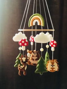 a mobile with animals and mushrooms hanging from it's sides