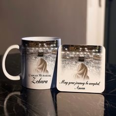 two coffee mugs sitting on top of a table next to each other with the same image