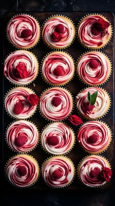 red velvet cupcakes with white frosting and rose petals on a baking sheet