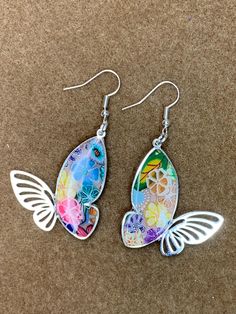 I made this lovely pair of earrings using a silver butterfly frame and my polymer clay floral pattern and silver plated ear wires. Dangle measure 1 1/2 inch. Multicolor Butterfly Earrings For Pierced Ears, Whimsical Butterfly Earrings With Ear Wire, Multicolor Butterfly Earrings, Nickel-free Adjustable Butterfly Earrings, Silver Butterfly Earrings With Ear Wire, Multicolor Butterfly Charm Earrings, Multicolor Butterfly Charm Earrings As Gift, Sterling Silver Butterfly Earrings With Ear Wire, Silver Whimsical Flower Earrings