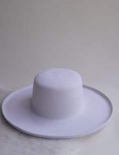 Just like in the Hampton's, the bigger the better. Introducing our biggest hat yet. Unique & elegant, featuring a pencil brim, and flat boater top. Lined with luxury stain and a stiffened brim. Band included, but removable. 100% Australian wool wide brim felt hat. Adjustable- Velcro drawstrings under interior band. To prefect/downsize the fit up to 2cm. Brim- 10cm Height- 11cm Structure- Stiff Our Felt hats are made from wool. Wool is natural, biodegradable, recyclable, & renewable IMPERFECT COL Wide Brim Felt Hat, Winter Headwear, Packable Hat, Hat Fedora, Felt Hats, Trendy Beach, Big Hat, A Pencil, Felt Hat