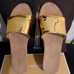 New Sandals Mirror Metalic Gold Flat Mules For Spring, Gold Slip-on Mules For Spring, Gold Flat Heel Mules For Party, Party Gold Flat Heel Mules, Gold Wedge Sandals With Cushioned Footbed For Vacation, Elegant Gold Slide Sandals, Gold Slide Mules For Spring, Gold Slide Mules For Summer, Gold Cushioned Sandals For Summer