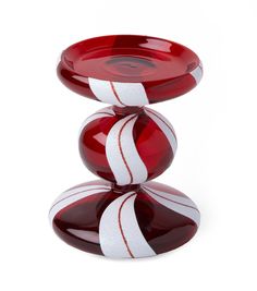 three red and white glass bowls stacked on top of each other in the shape of balls