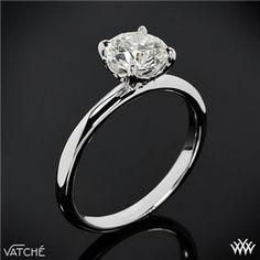 a white gold engagement ring with a round diamond