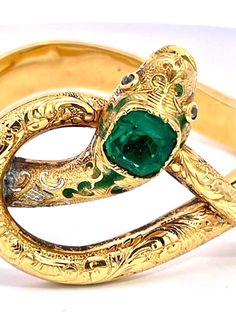 Here we go again with another magnificent snake bracelet.  By now you all know that I love snake jewelry and I am always on the lookout for great special snakes.  This snake bracelet comes out of France is is from the turn of the century approximately 1900 to 1910 and has a full etches or chased front.  At one time there was green enamel around the head but that has faded but it does not distract from the beauty of this piece.  The Emerald Head is synthetic the rest is gorgeous.  This weighs 20. Here We Go Again, Emerald Bracelet, Snake Jewelry, Snake Bracelet, Turn Of The Century, Fine Jewelry Bracelets, Green Enamel, Bracelets And Charms, Favorite Jewelry