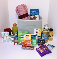 an assortment of food items sitting on top of a white counter next to a bag