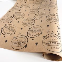 a brown wrapping paper with black and white stickers on it that says tying the knot