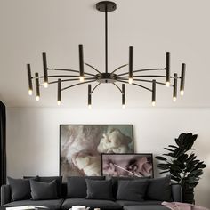 a living room filled with furniture and a large chandelier hanging from the ceiling